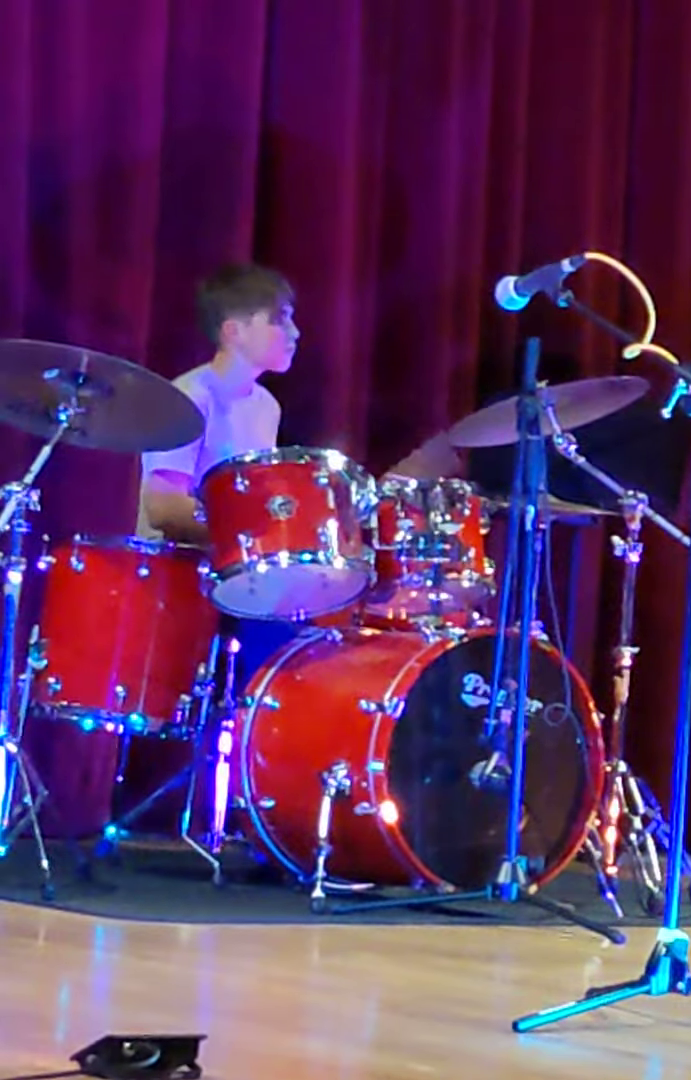 Tom playing drums with his school band