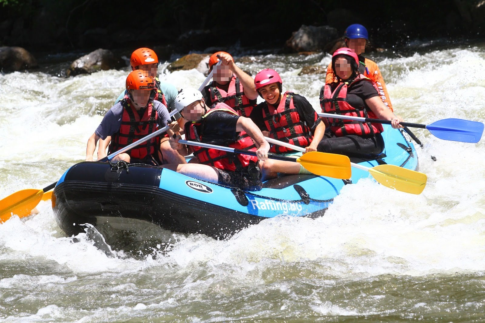 Tom rafting with a group through white water