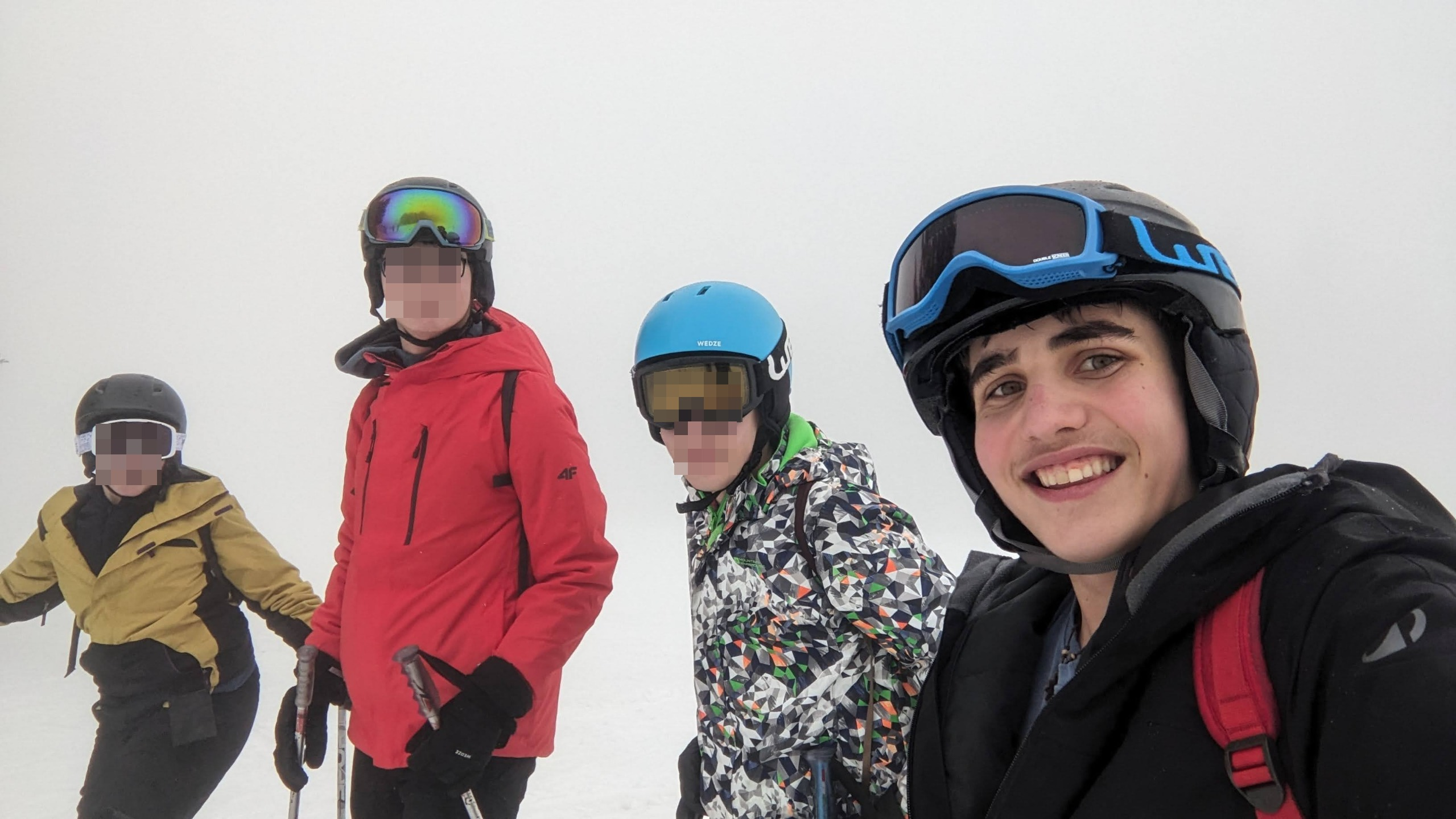 Tom skiing with friends on a snowy slope