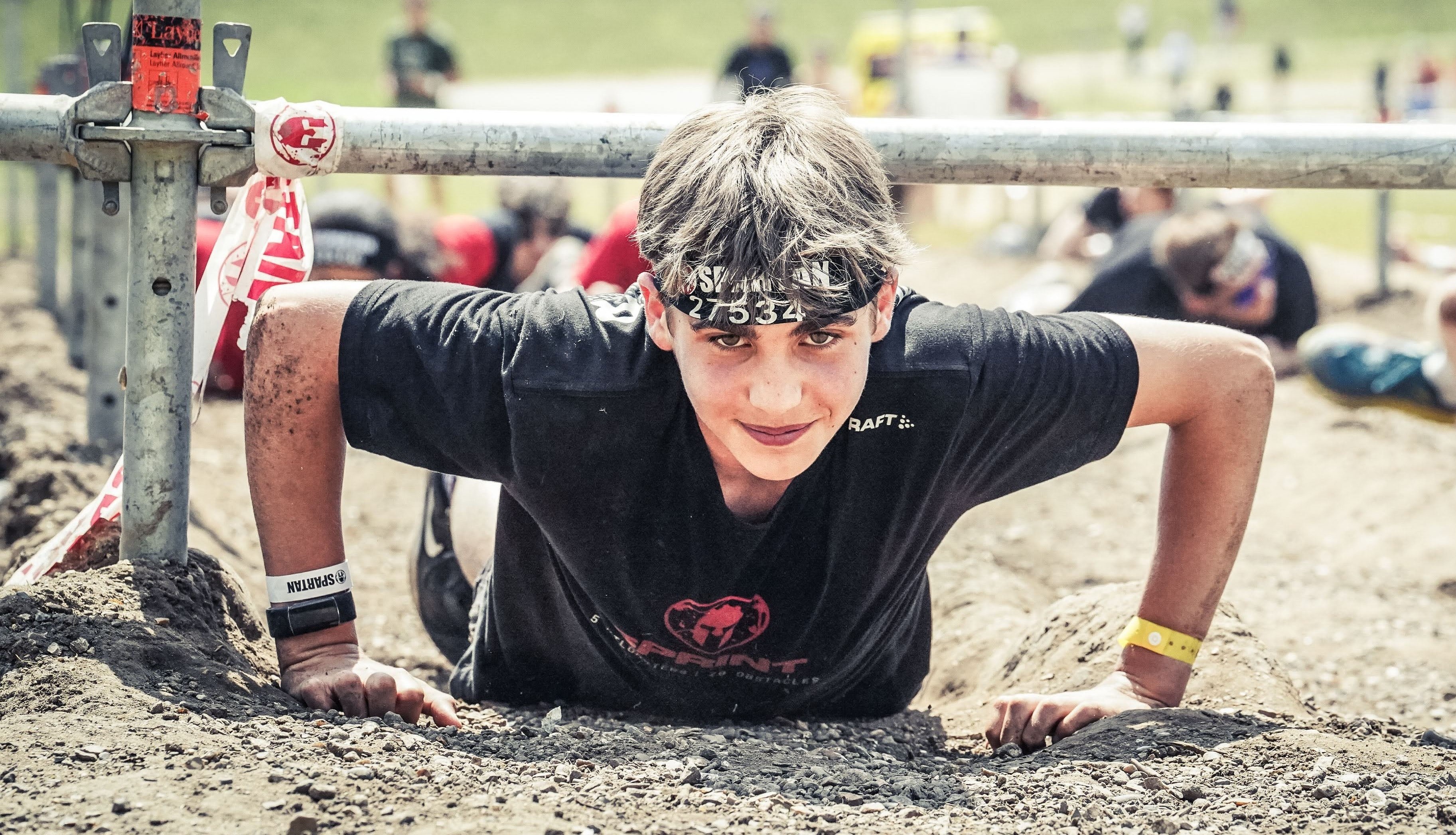 Me in a spartan race, looking up from a barbed wire crawl